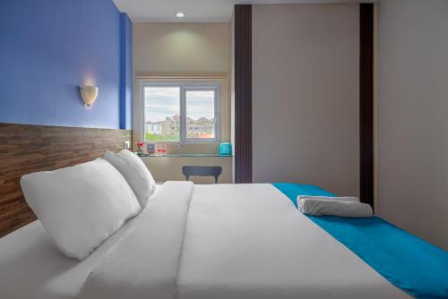 金巴兰梦@金巴兰酒店的窗户客房内的一张大白色床