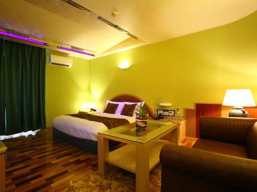 鸟栖市HOTEL Villamure ogori的酒店客房,配有床和沙发
