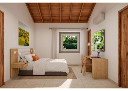 MonterrosoReverence Villas Fufin的一间卧室配有一张床、一张书桌和一个窗户。