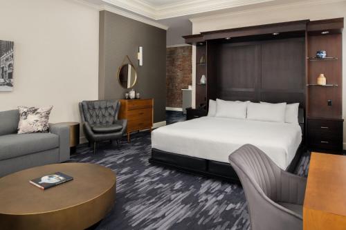 塔科马塔科马市中心万怡酒店的酒店客房配有床、沙发和桌子。
