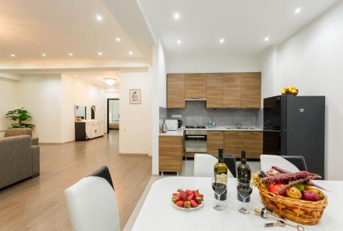 第比利斯Premium 2 Bedroom Apartment lll的厨房以及带水果篮桌子的客厅。