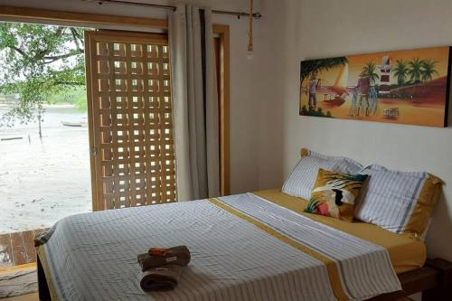MaracanãCasa Mari - ilha de Algodoal的一间卧室,配有一张床,上面有帽子
