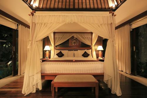 塞米亚克巴厘岛赛亚斯套房酒店的一间卧室配有一张带天蓬的床