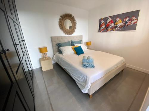 拉隆德莱丝莫里斯Appartement privé à la Villa Paradis de Valcros的一间卧室,床上有两双蓝鞋
