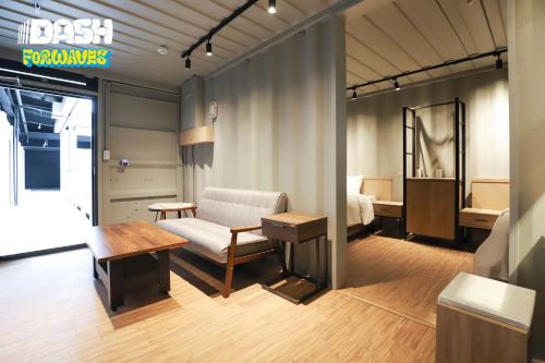 Hsin-hsing達煦浪花旅店的客房设有床、沙发和桌子。