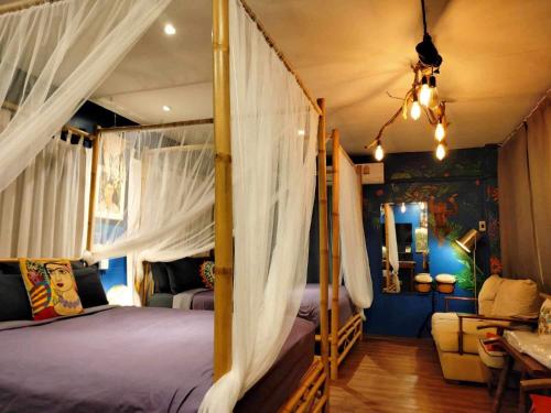 曼谷Nego Home Ancient Inn的一间卧室配有带窗帘的天蓬床