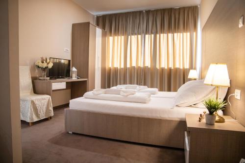 梅特科维奇Hotel Narenta的一间卧室设有一张大床和一个窗户。