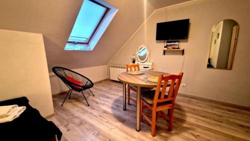 波拉齐克Zielona Przestrzeń的小房间设有桌椅和电视