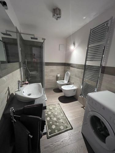 卡纳泽伊Dolomites Holiday Home的一间带两个盥洗盆和洗衣机的浴室
