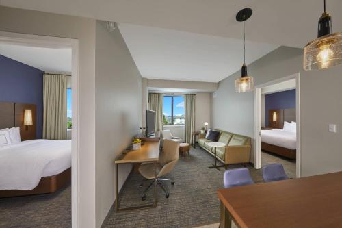 卡波雷Residence Inn by Marriott Oahu Kapolei的配有一张床和一张书桌的酒店客房