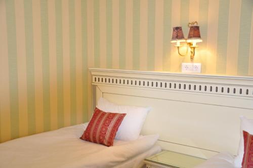 布勒伊拉Pensiunea Reset Club的一间卧室配有一张带床头板和灯的床