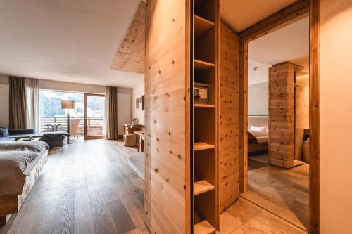 圣坎迪朵Naturhotel Leitlhof的卧室设有推拉门,通往客房