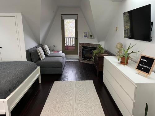 多伦多Bright, Private, Peaceful Suite with Retail Conveniences Steps Away的客厅配有床和沙发
