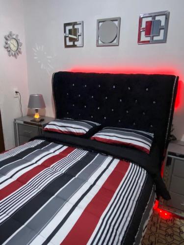海地角Juju House的一间卧室配有一张黑色床头板的床