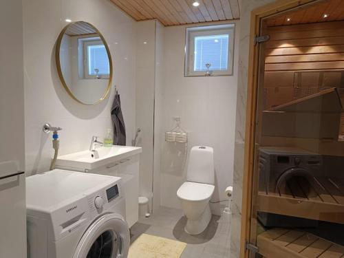 约恩苏Uusi kaksio parvekkeella ja autopaikalla的浴室配有卫生间水槽和洗衣机。