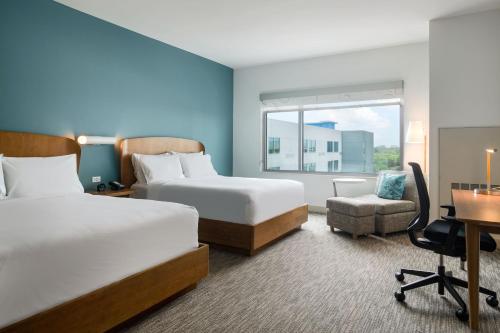 奥兰多Element Orlando International Drive的酒店客房配有两张床和一张书桌