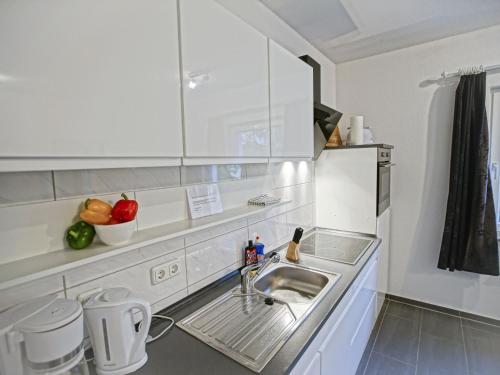 Mönkebude哈芙波罗的海度假屋的厨房配有水槽和水果柜台。