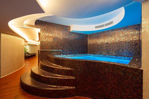 巴尔Hotel De‘Andros Virpazar的一间带按摩浴缸和楼梯的浴室