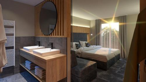 弗拉绍莱斯维特全家酒店的一间带水槽、床和镜子的浴室