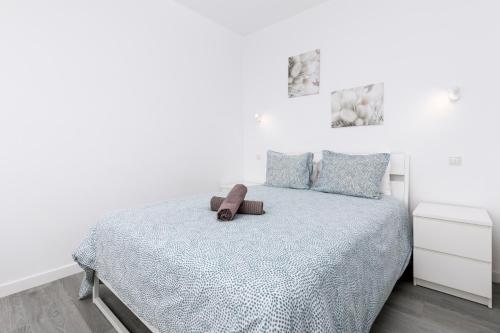 LajitaLa Lajita Barca Beach的白色卧室,床上有棕色带