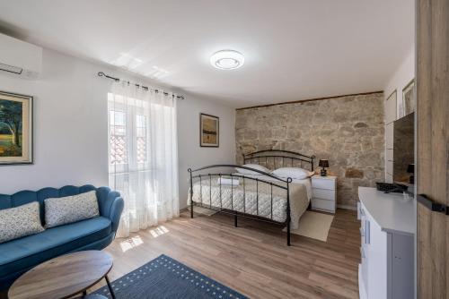 斯普利特里瓦长廊度假屋的一间卧室设有一张床和石墙