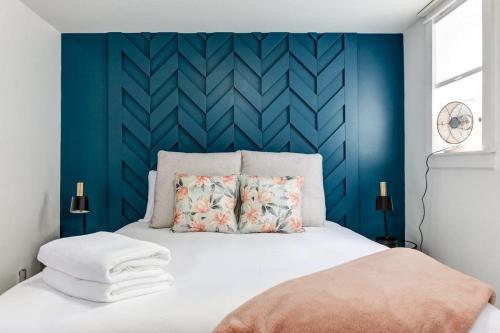 皮克顿The Ivy Suite at Portage House in Picton的一间卧室设有蓝色墙和一张床