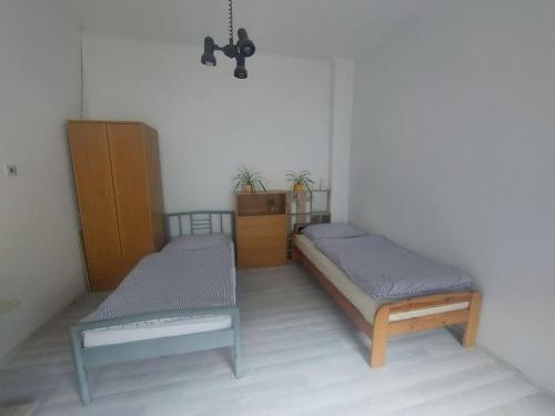 皮耶什佳尼Dom v centre Piešťan的客房设有两张单人床和梳妆台。