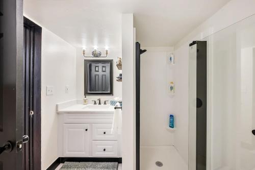 丹佛Charming & Updated Garden Level in Heart of Denver的白色的浴室设有水槽和镜子