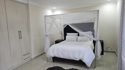 KitweArtem Apartments - Apartment 1的一间卧室配有一张带天蓬的白色床