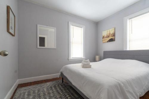 底特律Stylish 2-Story Home with Workspace的一间白色卧室,配有床和2个窗户