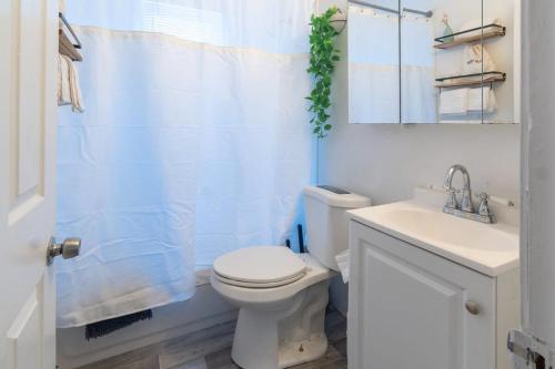 底特律Stylish 2-Story Home with Workspace的白色的浴室设有卫生间和水槽。