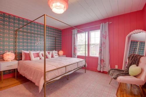默特尔比奇Inn the Pink One-in-a-Million Vacation Home的粉红色的卧室配有床和椅子
