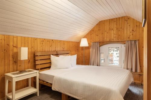 拉格斯Krone by b-smart的木镶板客房内的一张床位