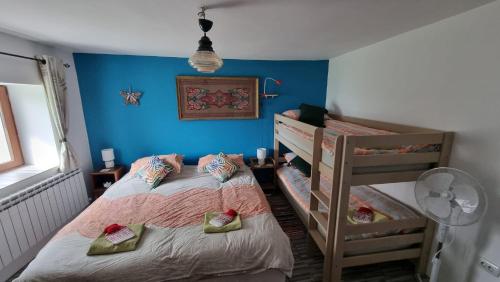 VezenkovoCalla Retreat的一间卧室设有两张双层床和蓝色的墙壁