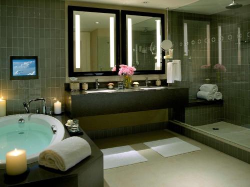 洛杉矶洛杉矶比弗利山庄索菲特酒店的带浴缸、水槽和两面镜子的浴室