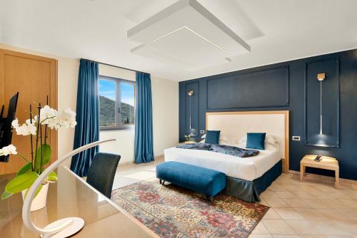 莱万托阿金图公园酒店的一间卧室配有一张蓝色墙壁的床和一张桌子