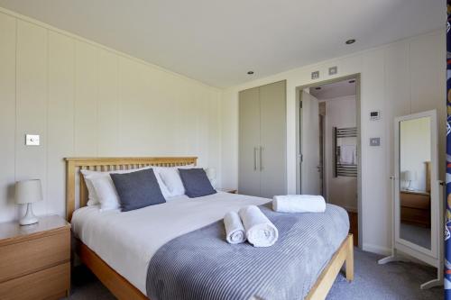 贝克因顿Farleigh Lodge的一间卧室配有一张大床和毛巾