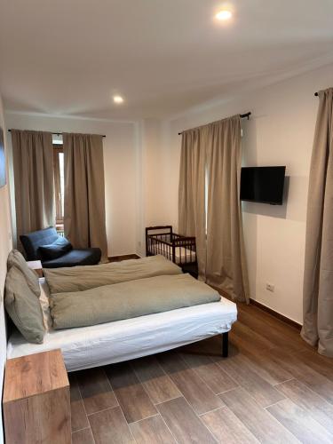 PiaggiaLa Briga的一间卧室配有一张床、一张沙发和一台电视