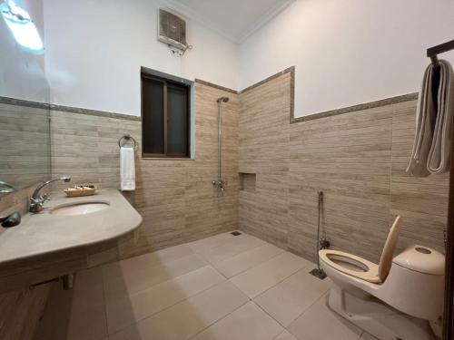 伊斯兰堡Rhodium Hotel ONE的浴室配有卫生间、盥洗盆和淋浴。
