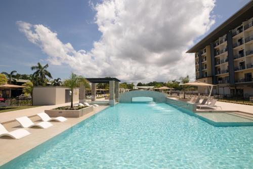 达尔文Ibis Darwin Airport Hotel的一个带椅子的游泳池和一间酒店