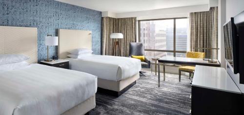 温哥华温哥华凯悦酒店的酒店客房配有两张床和一张书桌