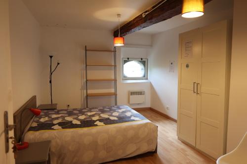 克罗勒Chambres de la ferme du Brocey的一间卧室设有一张床、梯子和窗户