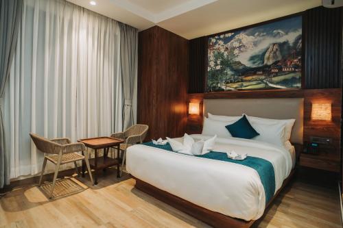加德满都Dees Boutique Hotel的酒店客房设有一张大床和一张桌子。