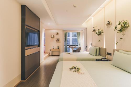 上海上海虹桥国展临空园区亚朵酒店的酒店客房设有两张床和电视。
