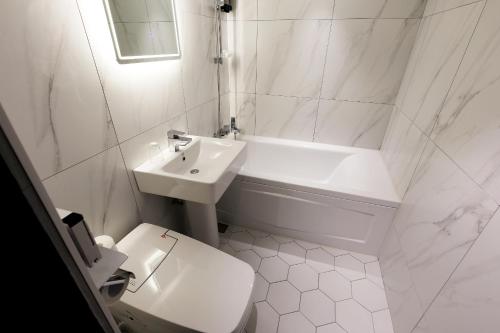 首尔Stay 25 Hotel的白色的浴室设有水槽和卫生间。