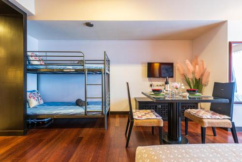 八打灵再也Resort Suite 6pax Homestay at Sunway Pyramid&Sunway Lagoon的客房设有一张床、一张书桌和双层床。