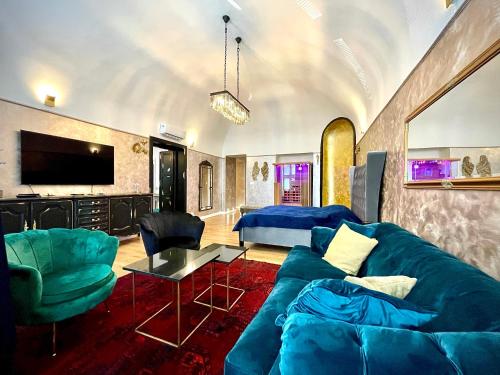 科希策Penzion Villa Regia的客厅配有蓝色的沙发和电视