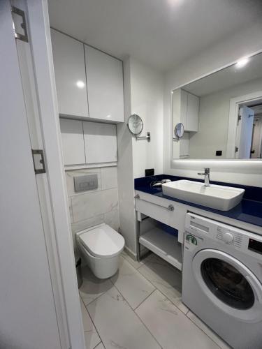 巴统Orbi City Hotel的浴室配有卫生间、盥洗盆和洗衣机。