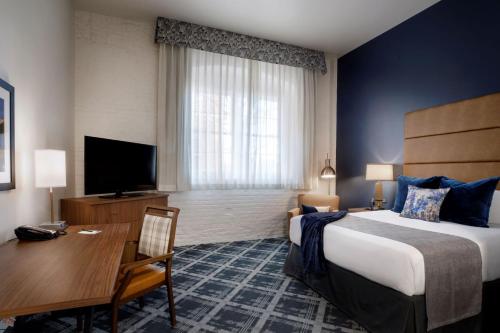 威奇托老城区酒店的酒店客房设有一张大床和一张书桌。