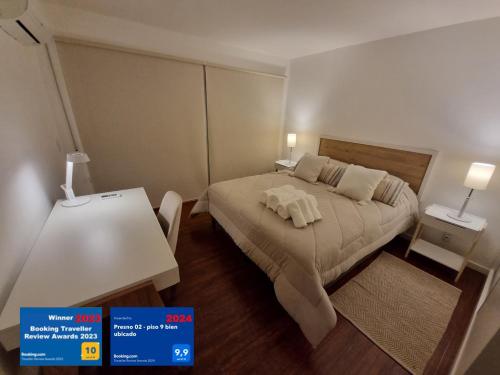 蒙得维的亚PRESNO 01- piso 9 bien ubicado的一间卧室配有一张床和一张带两盏灯的桌子。